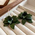 Close-up of dark green resin flower earrings featuring delicate petal details. - Flower (HE20328) / Green