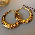 Macro view of geometric U-shaped leopard print hoop earrings on textured grey background - Geometric U-Shaped Large Earrings / Steel Earring Post / Gold Leopard Orange