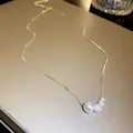 Close-up view of an elegant French style gold necklace with four graduated pearls - Gradient Size Pearl (2#)