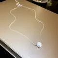 Detailed macro shot of a French mermaid pearl necklace featuring a single white bead - Freshwater Pearl Pendant (9#)