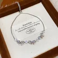 Close-up of elegant silver-colored bracelet with zircon butterfly charms in a gift box - Bowknot Style (HB5086) / Silver