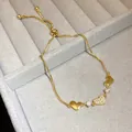 Delicate adjustable gold-plated heart bracelet with shimmering zircon stones on display - Heart Style (HB5089) / Gold