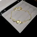 Elegant gold butterfly bracelet with shimmering zircons and opal-like center stone - Butterfly Flower Style (HB5087) / Gold