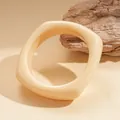 Creamy beige irregular resin bangle with a glossy finish in a minimalist retro style. - Irregular Geometric Polished Style / Beige