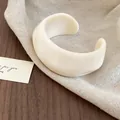 Chunky cream white resin cuff bracelet featuring a minimalist retro geometric design - Wide Open Circular Style / White