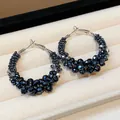 Close-up detail of vintage-style hoop earrings featuring faceted black glass beads - Large / Blue/Silver