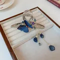 Pince à cheveux argentée élégante avec papillon brodé bleu et longues franges perlées - Style Papillon Brodé à Gland (12#) / Argent