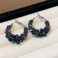 Close-up of vintage hoop earrings with dark navy faceted glass beads in a clustered design. - Small / Blue/Silver