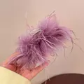 Detailed view of the fluffy purple feather hair claw clip for elegant hair styling - Purple Feather Style