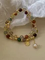 Close-up of vintage multi-colored beaded bracelet with gold coin and pearl charm - Queen Coin Pearl Drop Bracelet (1#) / Gold Brown