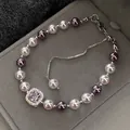 Close-up of a French vintage pearl bracelet with a purple gemstone and adjustable chain - Square Zirconia Adjustable Bracelet (12#) / Silver Purple Pink