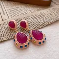Macro view of vintage palace style teardrop earrings with magenta stones and blue crystals - Oval Water Drop Style (HE17060)