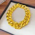 Detailed macro view of a chunky golden acrylic chain necklace on a minimalist display - 50cm / Gold
