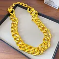 Detailed view of a high-shine gold acrylic chunky chain necklace on a display tray - 90cm / Gold