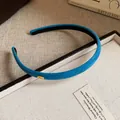Close-up of blue flocked fabric headband featuring an elegant gold Love charm - Light Blue