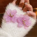 Sweet mosh-style purple flower earrings with pearl centers on soft white fuzzy glove - Pearl Center (31#) / Silver Earring Post Style / Purple