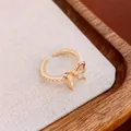 Elegant gold bow-shaped open ring with zircon and pearls on beige background - Mori Style Bow Pearl Style (WR271) / Gold