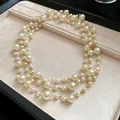 Close-up of multi-strand faux pearl necklace with gold-tone chain in a jewelry tray - French Multi-layer Long Style (HN7327) / Gold and White