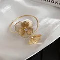 Detailed view of the gold mesh flower bangle with sparkling center rhinestones - Cuff Bracelet / Gold