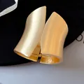 Detail view of a wide asymmetric minimalist matte gold cuff bracelet with a hinge. - Brushed Style (3#)