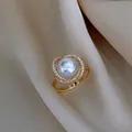 Elegant gold ring with central pearl and sparkling zircon floral halo on silk fabric - Zirconia Petal Pearl Style (WR271) / Gold