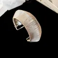 Macro detail of high-shine silver wire-wrapped geometric open arm cuff bracelet - 3# Geometric Wire Wrap Style / Silver