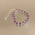Close-up of purple heart-shaped zircon bracelet on a reflective mirror surface - Style 6 (Silver-Purple)