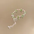 Close-up of a sparkling silver bracelet with green and white marquise-cut zircons - Style 5 (Silver-Green)
