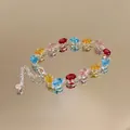 Macro view of luxury colorful oval-cut zircon bracelet resting on a mirrored surface. - Style 3 (Multicolor)