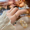 Elegant gold-tone heart ring with rectangular zirconia accents, adjustable open band design - Hollow Heart