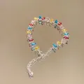 Detailed view of colorful rectangular zircon bracelet on reflective surface. - Style 1 (Multicolored)