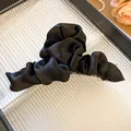 Detailed view of elegant black ruched fabric hair claw clip with smooth silk texture finish - Black Claw (Style 2)