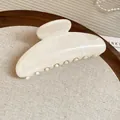 Close-up of a elegant cream marble texture hair claw clip on a wooden display tray - Marble Cream Style 46