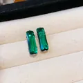 Close-up of elegant emerald green rectangular zircon stud earrings on beige tray - Large / Green