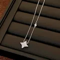 Elegant silver-tone necklace with a radiant star-shaped pendant and cubic zirconia. - Chain Only / Silver