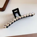 Detailed macro view of elegant black hair claw clip with sparkling heart-shaped crystals - 6# Claw Clip - Black With Rhinestone Heart