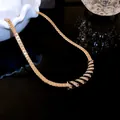 Close-up of gold-plated necklace with black enamel and sparkling rhinestones - Black Gold Striped Style / Gold