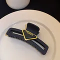 Elegant matte black shark hair claw clip with a stylish golden POWER triangle design - 21# Grip Clip - Black Wide Triangle Letter