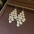 Detailed view of elegant shell petal tassel earrings with sparkling zircon stones - Ear Hooks - Gold - White