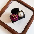 Elegant black pearl hair claw clip with a purple fabric button and gold bow detail - 26# Claw Clip - Black Bow Pearl Small Size