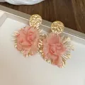 Close-up detail of pink fabric flower earrings with golden textured metal studs - 31# Silver Earring Post