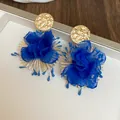Close-up of vibrant blue fabric flower earrings with textured gold metal studs. - Silver Post Style (5#) / Gold-Blue