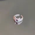 Close-up detail of a cute cartoon cat eye open ring featuring a purple bead on gray background - Monster Eye Style / Light Pink (Eyes)
