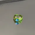 Close-up detail of a cute green monster adjustable ring with a unique large blue eye. - One-Eyed Monster Style / Green (Eye)