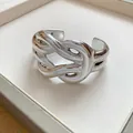 Detailed view of a chunky silver-colored cuff bracelet with a twisted knot design - Wrapped Geometric Horsehoof Style (8)