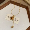 Macro detail of retro oval resin pendant on adjustable gold-toned sliding necklace chain - Oval Pendant / Gold