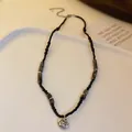 Elegant minimalist black beaded necklace featuring a vintage round silver pendant for women - Black Peace Lock