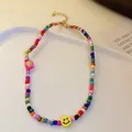Colorful beaded necklace with yellow smiley face and pink flower beads. - Colorful Seed Bead