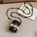 Detailed view of bohemian ethnic necklace crafted from coconut shells and white beads - White Round Style / Brown