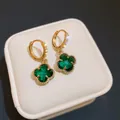 Elegant gold plated hoop earrings featuring sparkling green crystal four-leaf clover charms - Hoop Buckle Style / Green